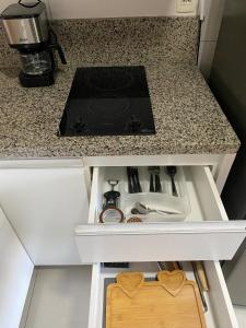 a kitchen counter with a stove top in a drawer at Excelente Ap no DF Century Plaza in Brasilia