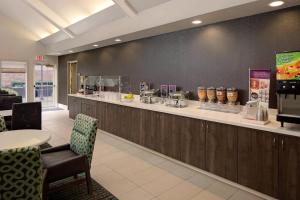 a restaurant with a counter with chairs and a counter top at Residence Inn Dallas DFW Airport North/Irving in Irving