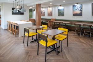 a dining room with tables and yellow chairs at Fairfield Inn and Suites by Marriott Lake Charles - Sulphur in Sulphur