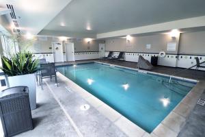 a large indoor swimming pool in a building at Fairfield Inn & Suites Des Moines Airport in Des Moines