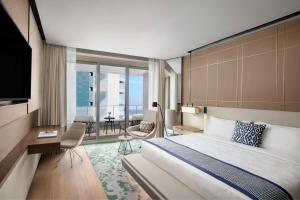 a hotel room with a large bed and a balcony at JW Marriott Hotel Istanbul Marmara Sea in Istanbul