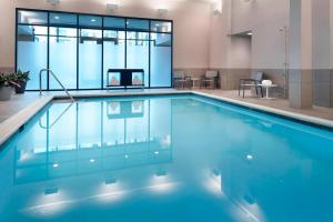 a swimming pool with blue water in a building at Marriott Columbus OSU in Columbus