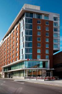 a large red brick building with glass windows at Ithaca Marriott Downtown on the Commons in Ithaca