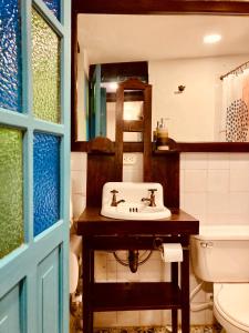 a bathroom with a sink and a toilet at Casa Aranjuez in Bogotá +72 photos