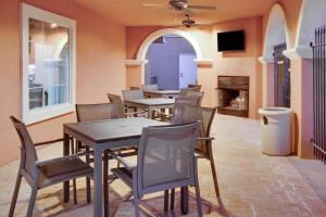 a dining room with tables and chairs and a fireplace at Residence Inn Midland in Midland