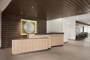 a lobby with a reception desk in a building at Fairfield Inn & Suites by Marriott Milwaukee West in West Milwaukee