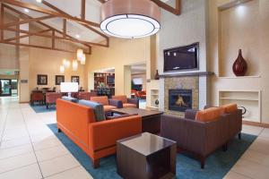 a lobby with couches and a fireplace and a tv at Residence Inn Grand Junction in Grand Junction