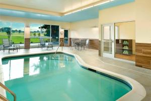 Fairfield Inn & Suites by Marriott Hendersonville Flat Rock في فلات روك: مسبح في بيت مع فناء