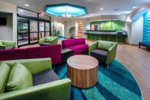 a lobby with colorful furniture and a bar at SpringHill Suites by Marriott Greensboro in Greensboro