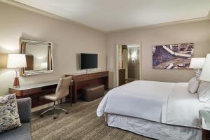 a hotel room with a bed and a desk at The Westin Chicago River North in Chicago