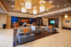 a lobby of a hotel with couches and chairs at Courtyard by Marriott Baldwin Park in Baldwin Park