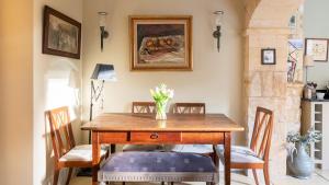 a dining room with a wooden table and chairs at Singer House in Chipping Campden