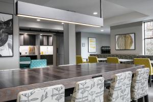 a dining room with a large table and chairs at Residence Inn by Marriott Lincoln South in Lincoln