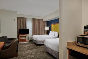 a hotel room with two beds and a television at SpringHill Suites by Marriott Baton Rouge North / Airport in Baton Rouge