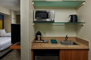 a kitchen with a sink and a microwave at SpringHill Suites by Marriott Baton Rouge North / Airport in Baton Rouge
