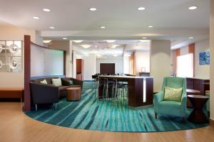 a lobby with a waiting room with chairs and a table at SpringHill Suites Los Angeles LAX/Manhattan Beach in Hawthorne