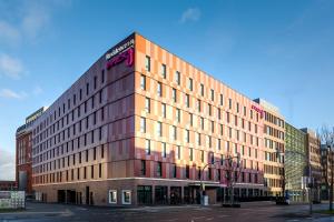 a large building on a city street at Moxy Dortmund City in Dortmund