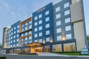 a large blue building with a hotel at Fairfield by Marriott San Jose Airport Alajuela in Alajuela City