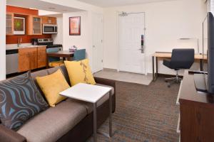 a living room with a couch and a kitchen at Residence Inn by Marriott Boise Downtown/University in Boise