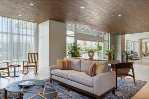 a living room with a couch and a table at Fairfield by Marriott San Jose Airport Alajuela in Alajuela City