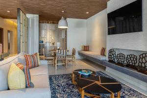 a living room with a couch and a table at Fairfield by Marriott San Jose Airport Alajuela in Alajuela City