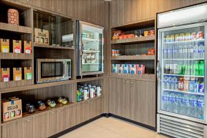 a kitchen with a refrigerator and a microwave at Fairfield by Marriott San Jose Airport Alajuela in Alajuela City