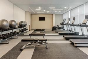 a gym with rows of treadmills and weights at Fairfield by Marriott San Jose Airport Alajuela in Alajuela City
