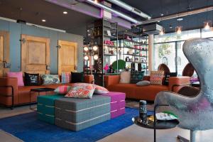 a room with a couch and chairs in a store at MOXY Frankfurt East in Frankfurt