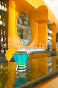 a blue martini sitting on top of a bar at Clearwater Beach Marriott Suites on Sand Key in Clearwater Beach