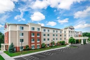 a rendering of a hotel with a parking lot at SpringHill Suites Long Island Brookhaven in Bellport