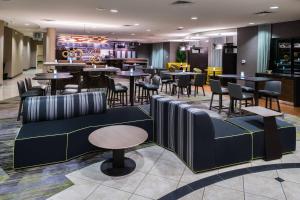 a restaurant with tables and chairs and a bar at Courtyard by Marriott San Luis Obispo in San Luis Obispo