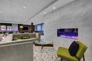 a lobby with couches and a fireplace in a hotel at Courtyard by Marriott Manhattan Aggieville in Manhattan