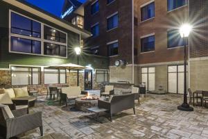 a patio with furniture and a fire pit in front of a building at Residence Inn by Marriott Cleveland Airport/Middleburg Heights in Middleburg Heights