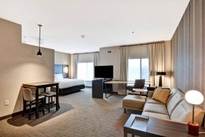 a living room with a couch and a bed at Residence Inn by Marriott Cleveland Airport/Middleburg Heights in Middleburg Heights