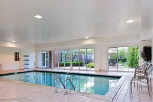 a large swimming pool in a house with windows at Residence Inn Detroit / Auburn Hills in Pontiac