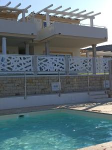 a house with a swimming pool in front of it at Welcomely - White Terrace - Condominio AcquaLife in Cannigione