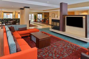 a living room with a couch and a large fireplace at Residence Inn by Marriott Des Moines Downtown in Des Moines