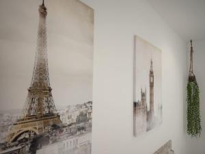 a picture of the eiffel tower next to a wall at Gallaecia in Arzúa +41 photos