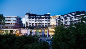 a group of buildings in a city at night at Hotel Ajda - Terme 3000 - Sava Hotels & Resorts in Moravske Toplice