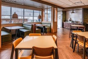 a restaurant with tables and chairs and windows at Fairfield Inn & Suites by Marriott Staunton in Staunton