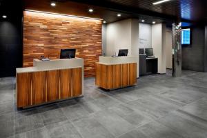 a lobby with two reception desks and a brick wall at Courtyard by Marriott Houston Intercontinental Airport in Houston