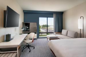 a hotel room with a bed and a desk at Courtyard Ames in Ames