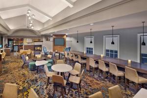 a large room with tables and chairs and a bar at Residence Inn by Marriott Fort Lauderdale Weston in Weston