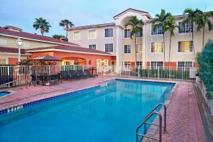 a swimming pool in front of a building at Residence Inn by Marriott Fort Lauderdale Weston in Weston