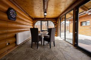 a dining room in a tiny house with a table and chairs at Cold River Resort in Dorna Arini