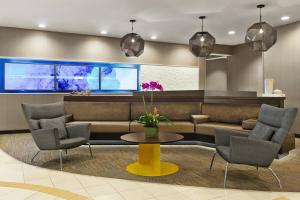 a lobby with a couch and chairs and a table at SpringHill Suites Dulles Airport in Sterling