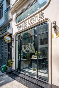 a white lotus store with a sign in the window at White Lotus Boutique Hotel, Ho Chi Minh in Ho Chi Minh City
