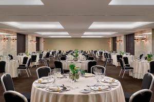 a banquet room with tables and chairs with white linens at Sheraton Lisboa Hotel & Spa in Lisbon +109 photos