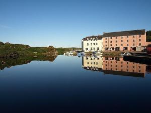 a large body of water with buildings and boats in it at The Clady in Bunbeg