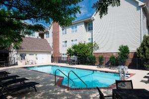 a swimming pool with tables and chairs next to a building at Residence Inn Denver Highlands Ranch in Highlands Ranch